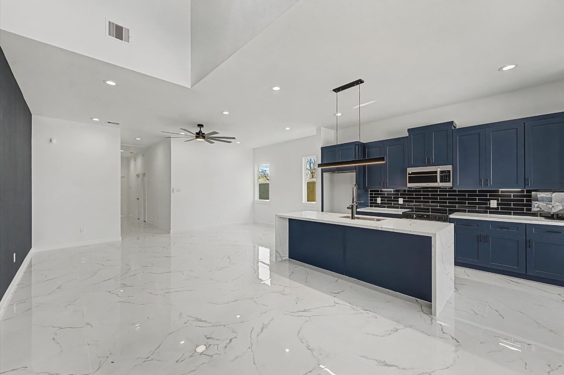5034 Pershing Street, Unit B Houston, TX 77033 - Photo 12 of 26 a kitchen with stainless steel appliances granite countertop a refrigerator and a stove top oven