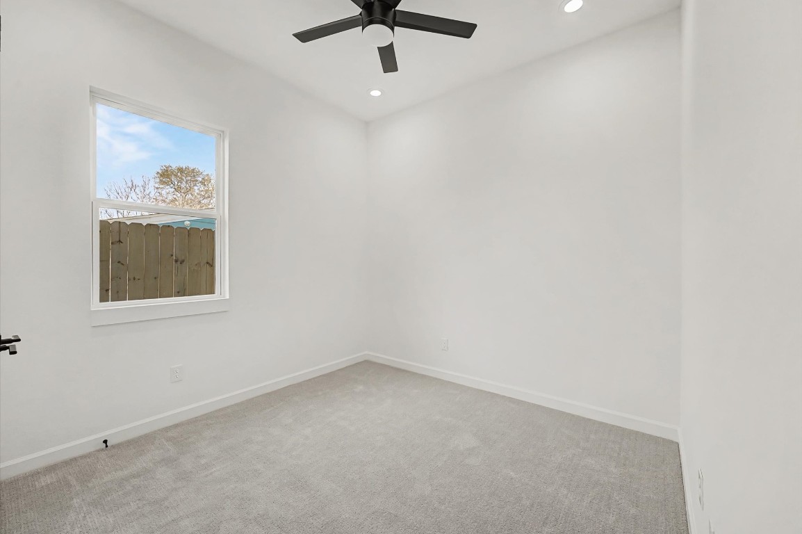 5034 Pershing Street, Unit B Houston, TX 77033 - Photo 18 of 26 an empty room with a ceiling fan and window