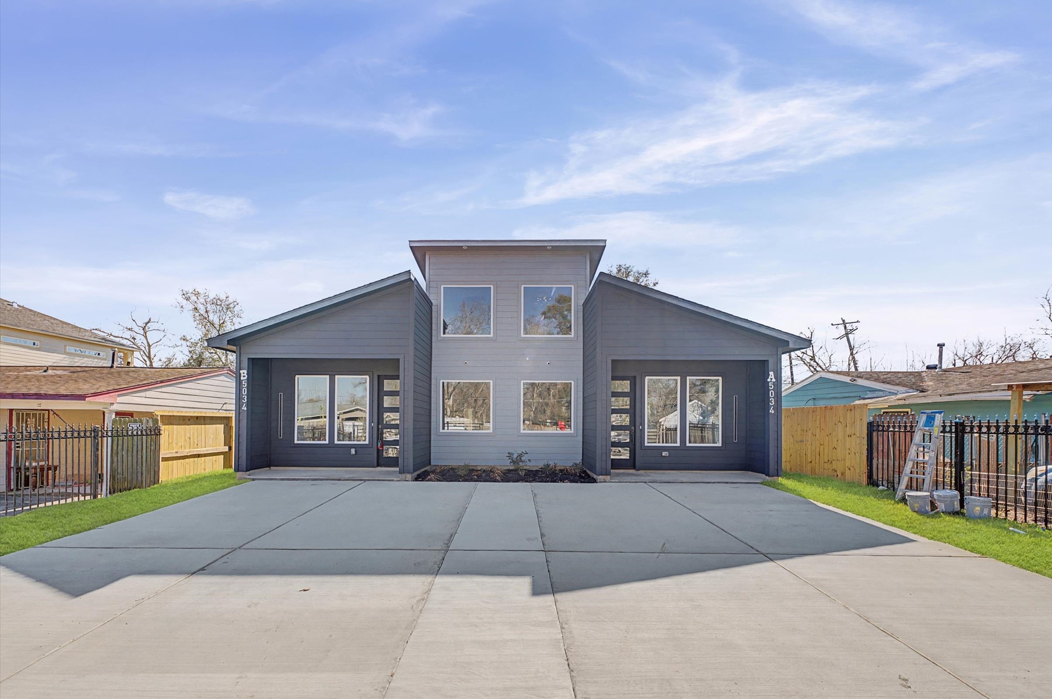 5034 Pershing Street, Unit B Houston, TX 77033 - Photo 2 of 26 a front view of a house with a yard and garage