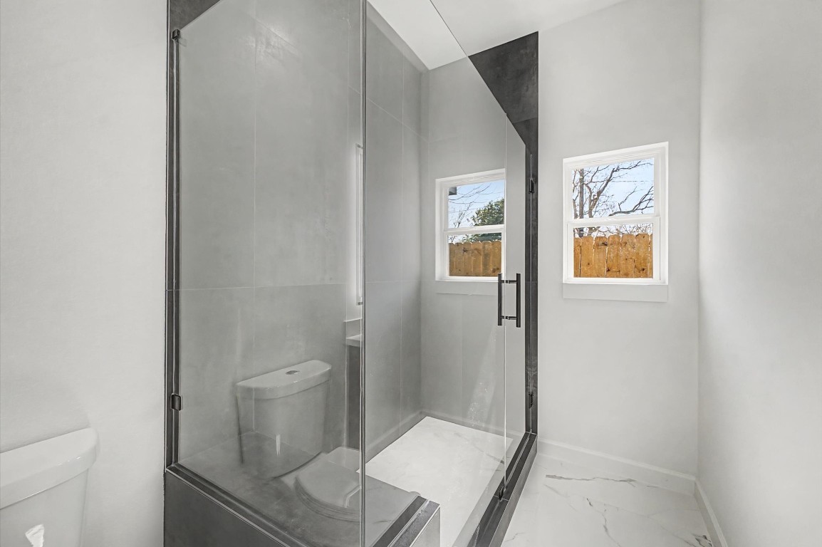 5034 Pershing Street, Unit B Houston, TX 77033 - Photo 22 of 26 a bathroom with a toilet and a shower