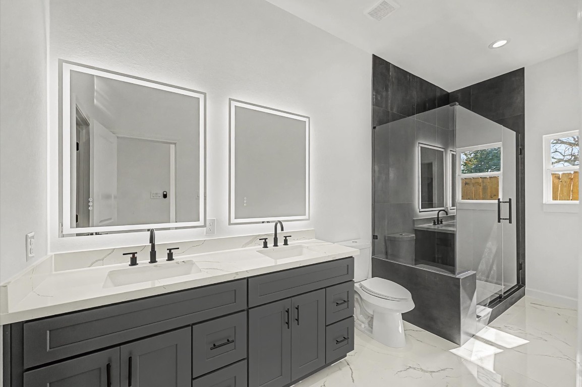 5034 Pershing Street, Unit B Houston, TX 77033 - Photo 24 of 26 a bathroom with a double vanity sink and a mirror