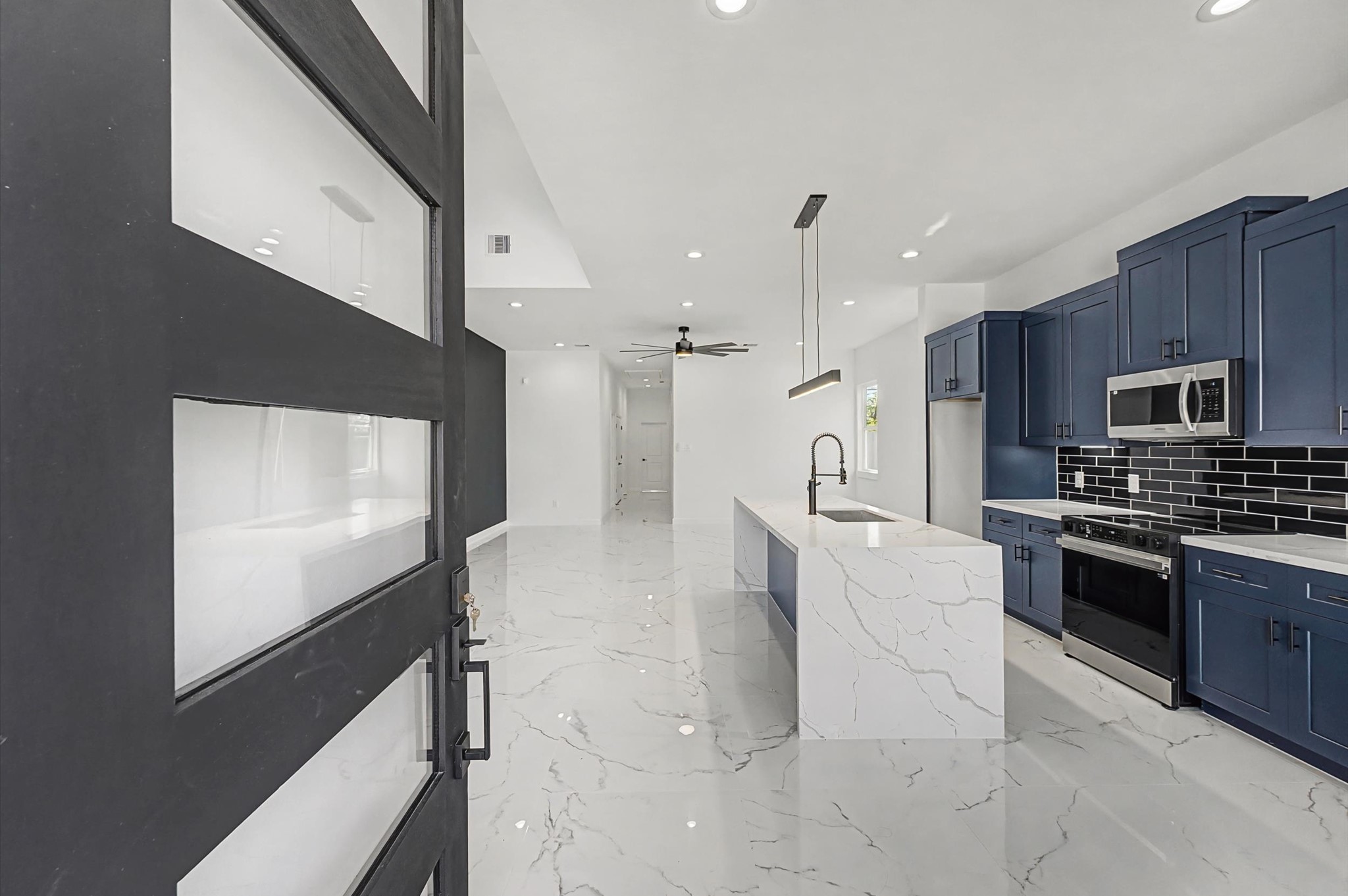 5034 Pershing Street, Unit B Houston, TX 77033 - Photo 7 of 26 a large kitchen with cabinets and stainless steel appliances