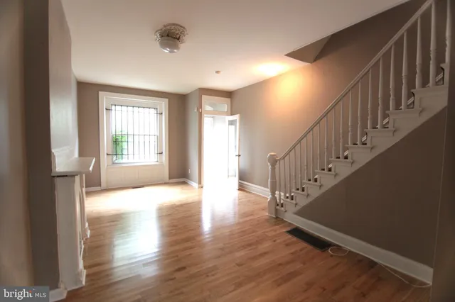 a view of an entryway with wooden floor