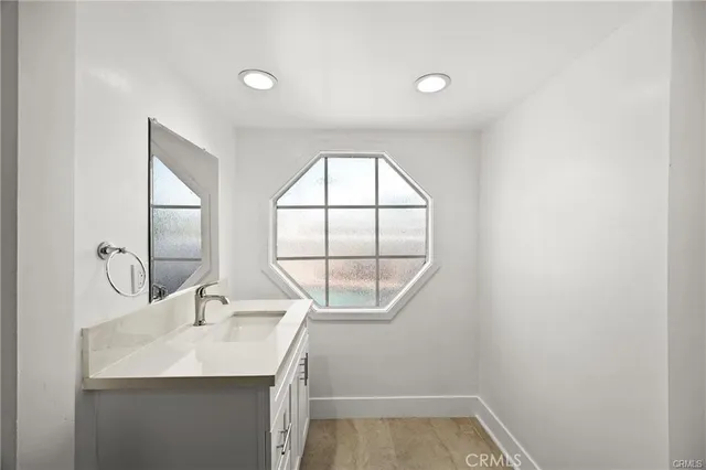a bathroom with a sink and a window
