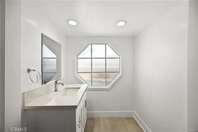 a bathroom with a sink and a window