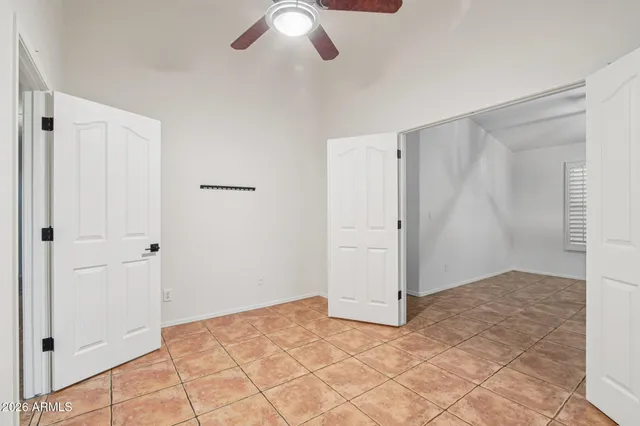 an empty room with closet and windows
