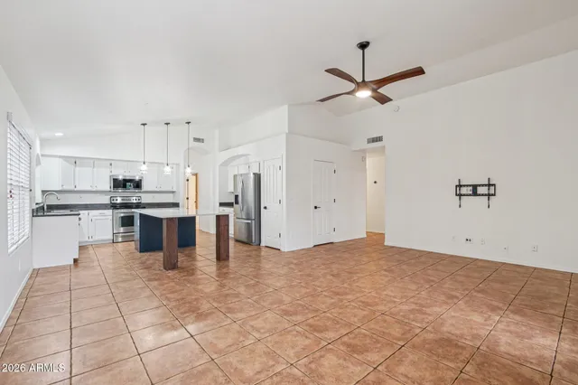 a kitchen with a stove kitchen island and stainless steel appliances