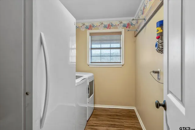a bathroom with a refrigerator and a window