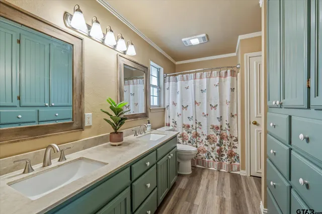 a bathroom with a double vanity sink and a mirror