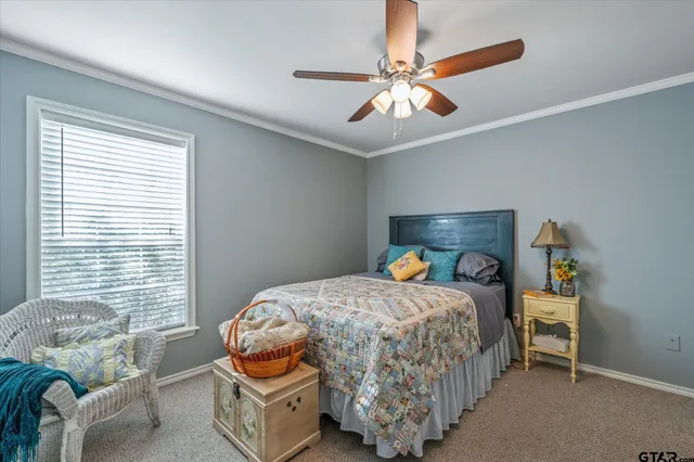 a bedroom with bed and a chandelier