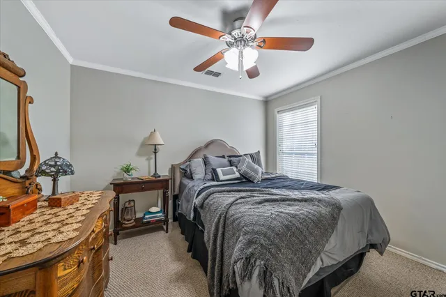 a bed sitting in a spacious bedroom next to a window