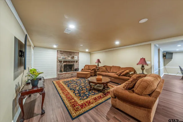 a living room with furniture flat screen tv and a fireplace