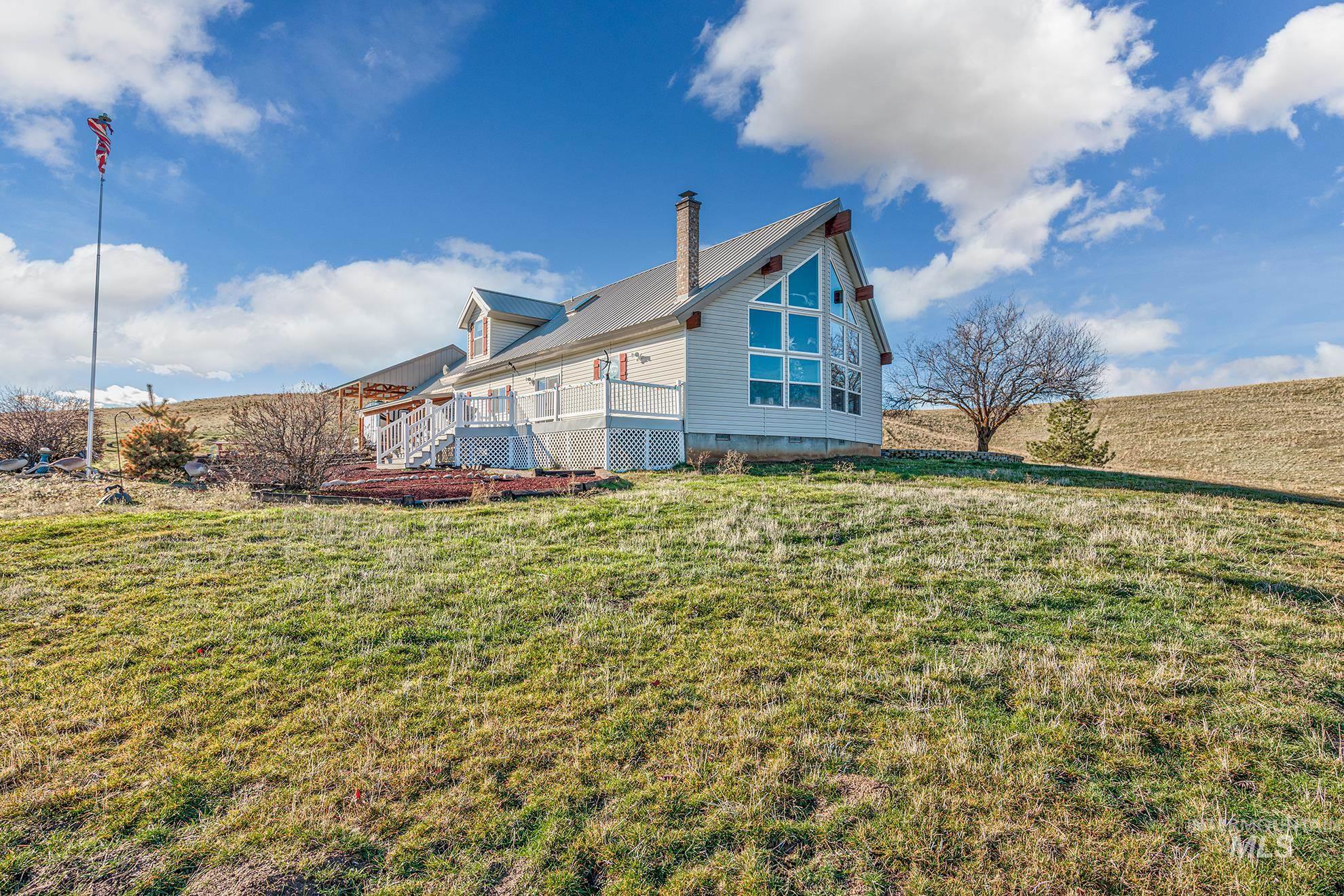 985 Highway 95 Weiser, ID 83672 - Photo 1 of 40 View of side of home with crawl space, a lawn, a deck, and a metal roof