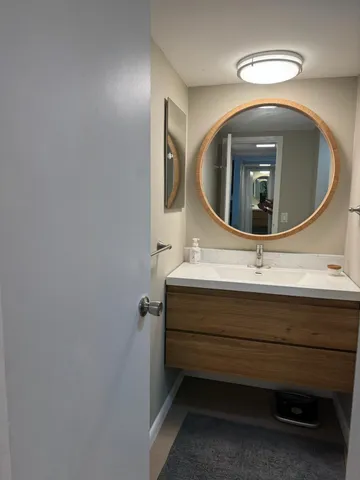a bathroom with a sink and mirror