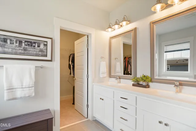a bathroom with a double vanity sink and a mirror