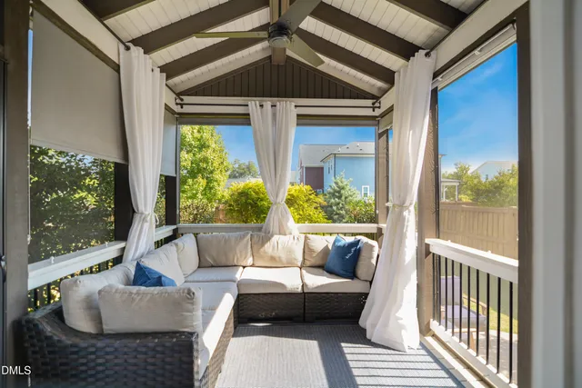 a balcony with furniture and a potted plant