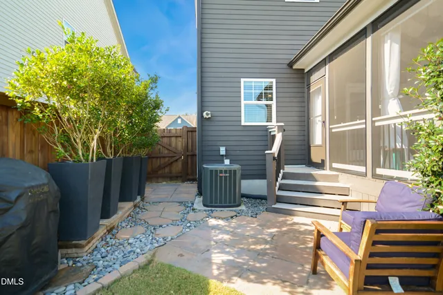 a view of a patio with table and chairs and wooden fence
