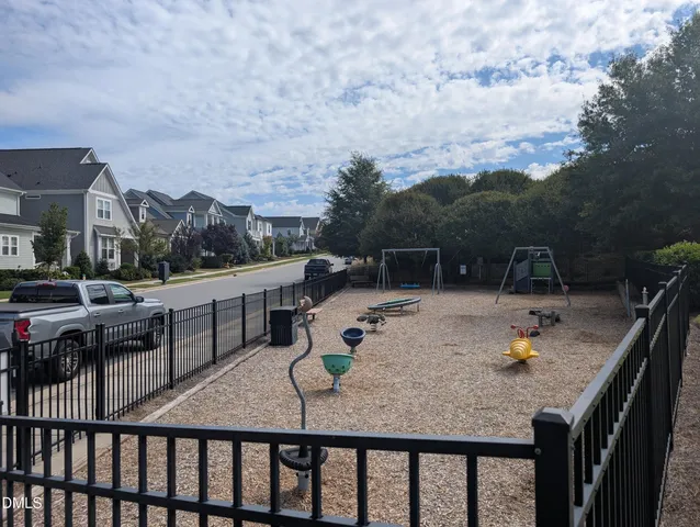 a backyard of a house with table and chairs