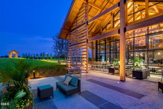 a view of a swimming pool with couches and lounge chairs