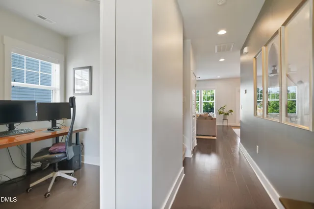 a view of a workspace with furniture and a window