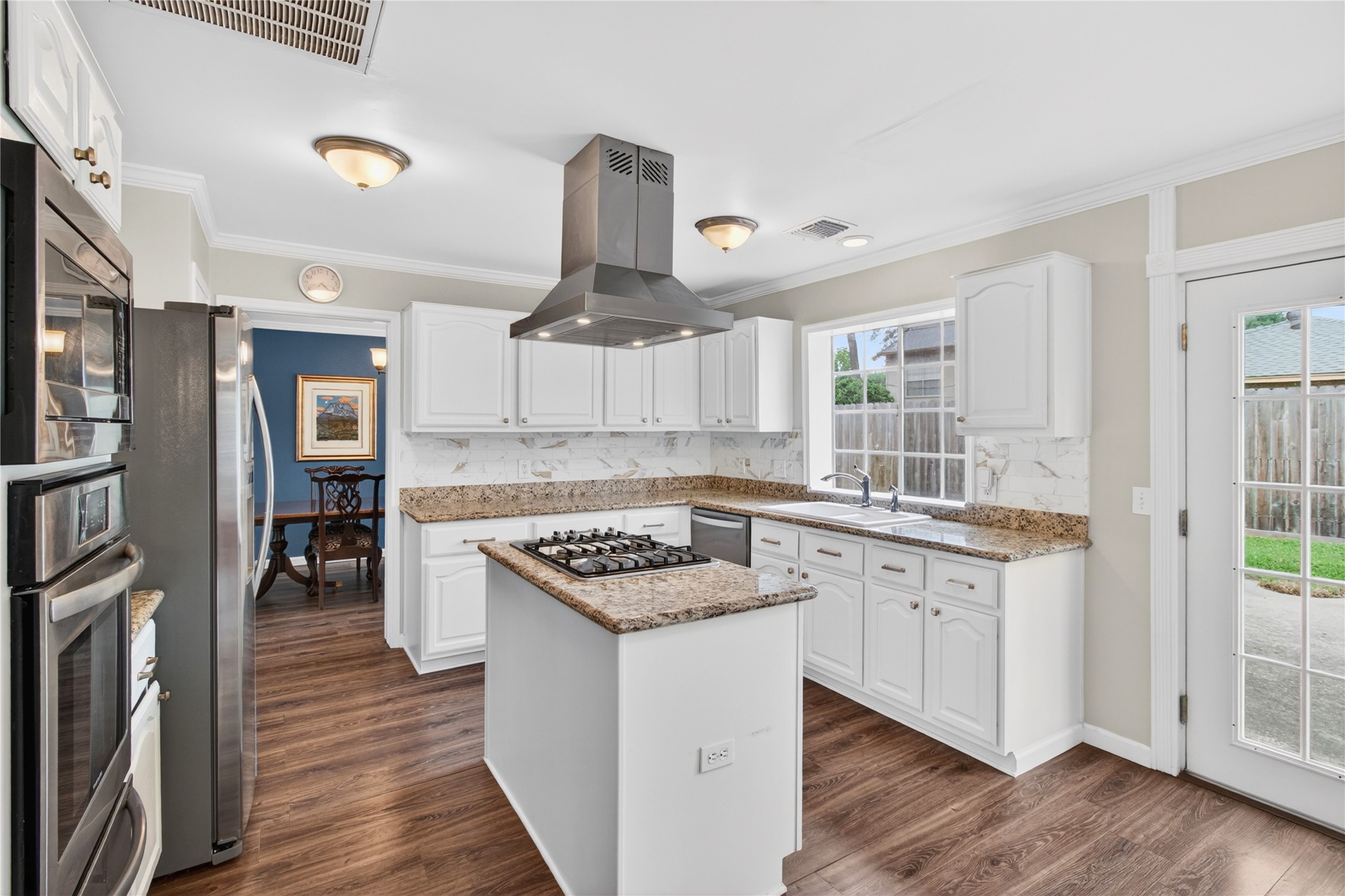 20214 Woodsboro Court Spring, TX 77388 - Photo 13 of 50 Recently Updated Kitchen! Painted cabinets, Stainless Appliances & Vent Hood, Tile Backsplash! Recently Painted Interior! Luxury Vinyl Plank throughout 1st Floor!