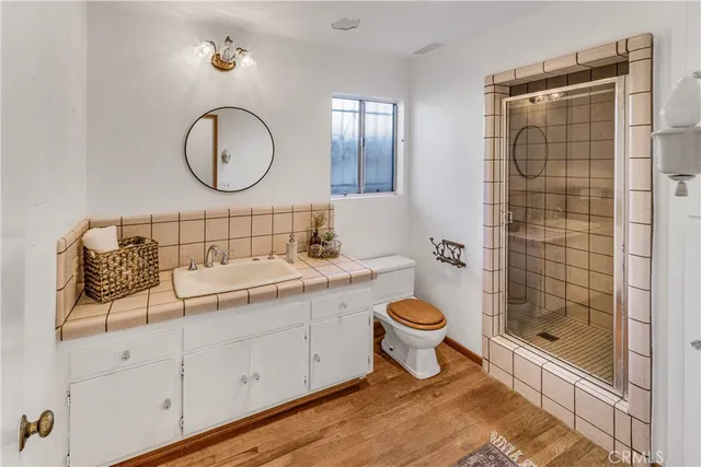 a bathroom with a toilet a sink and mirror