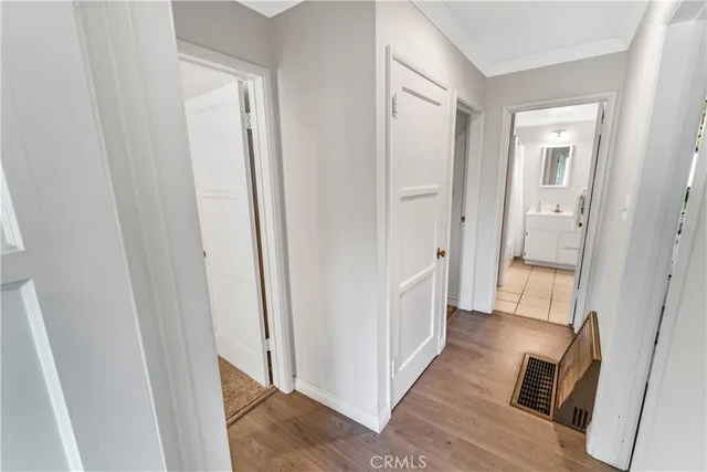 a view of a hallway with wooden floor and staircase