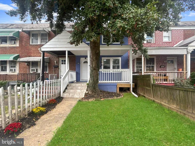 a front view of a house with a yard table and chairs