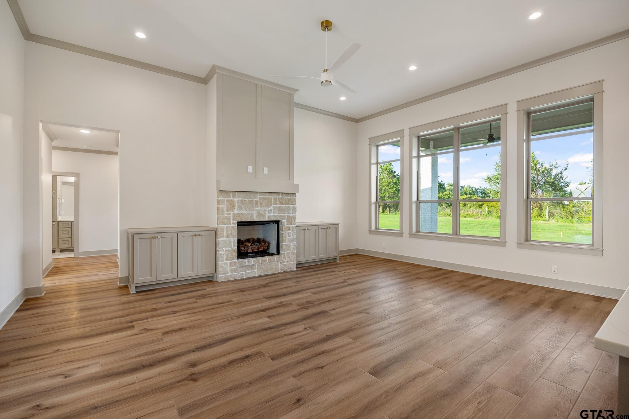 11410 Tucker Circle Flint, TX 75762 - Photo 11 of 43 a view of an empty room with wooden floor and a window