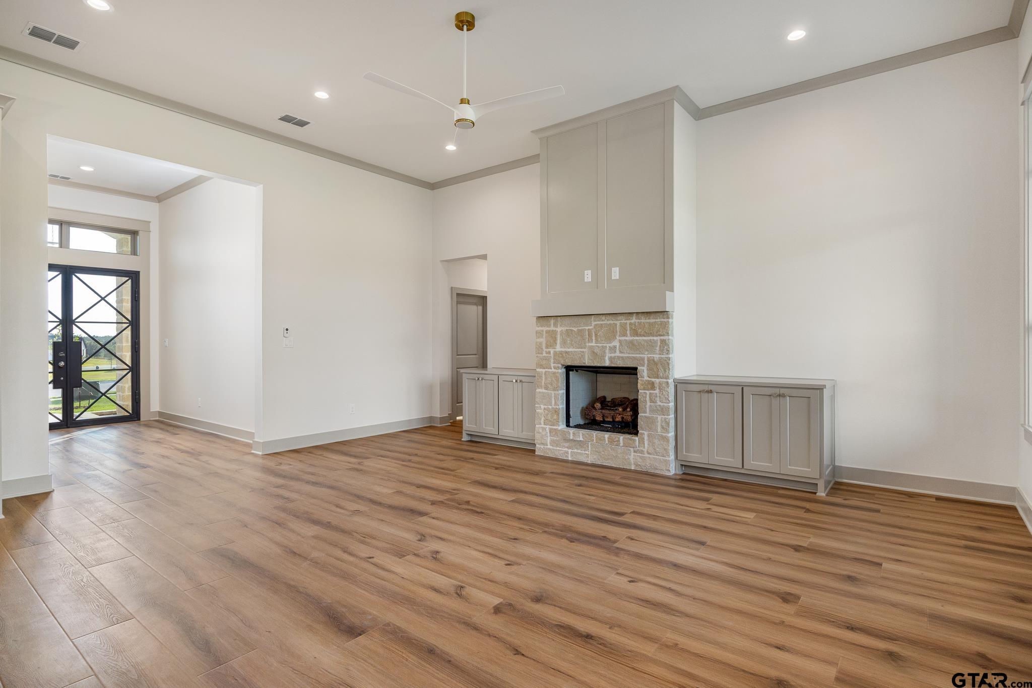 11410 Tucker Circle Flint, TX 75762 - Photo 12 of 43 an empty room with wooden floor fireplace and windows