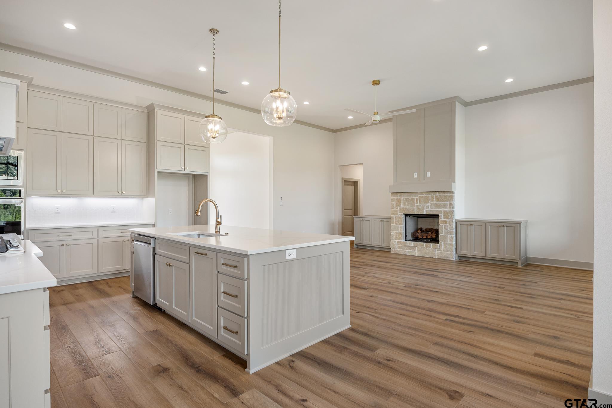 11410 Tucker Circle Flint, TX 75762 - Photo 16 of 43 a large white kitchen with kitchen island a sink a center island stainless steel appliances and a counter space