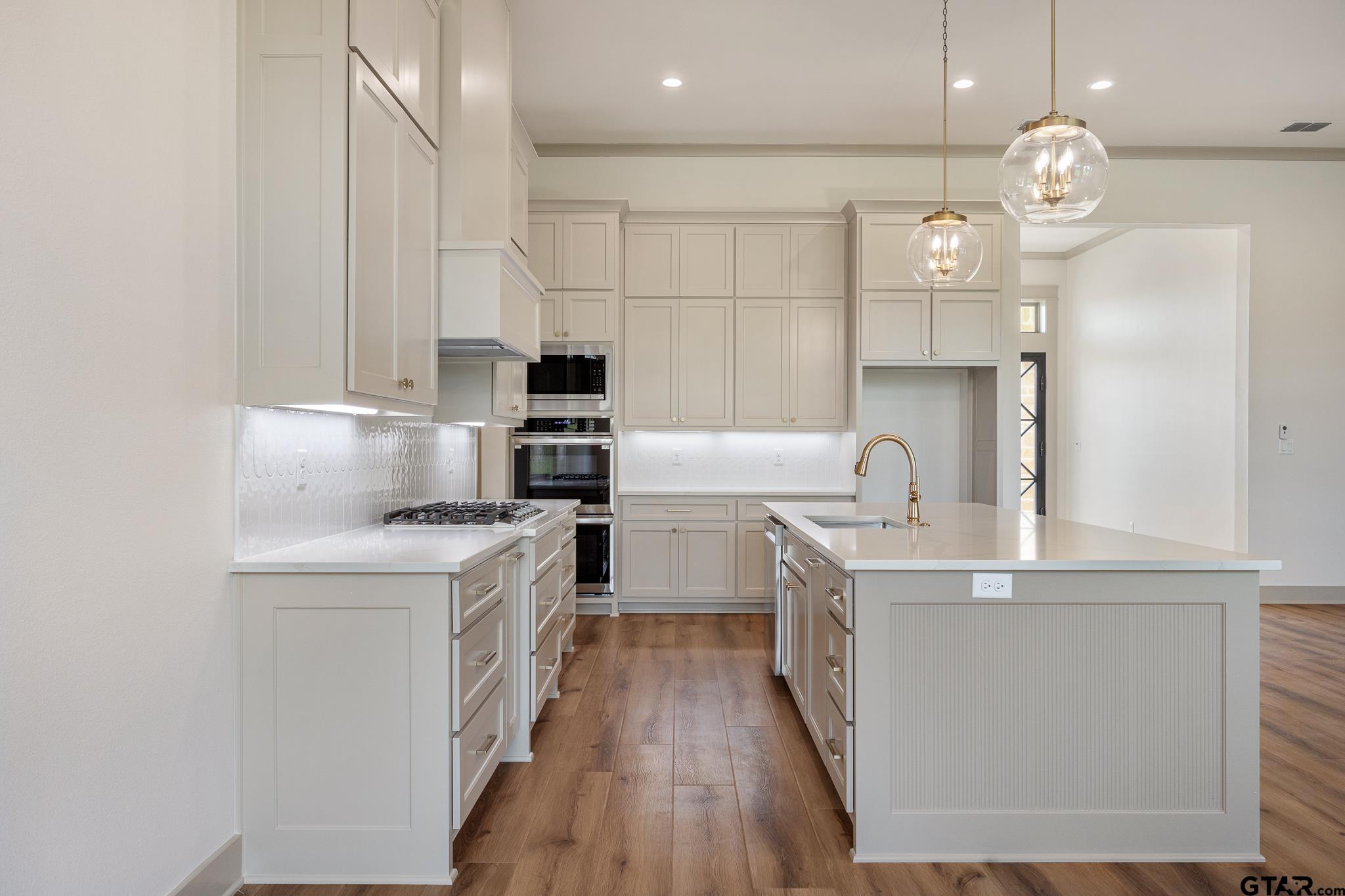 11410 Tucker Circle Flint, TX 75762 - Photo 17 of 43 a kitchen with kitchen island white cabinets and stainless steel appliances
