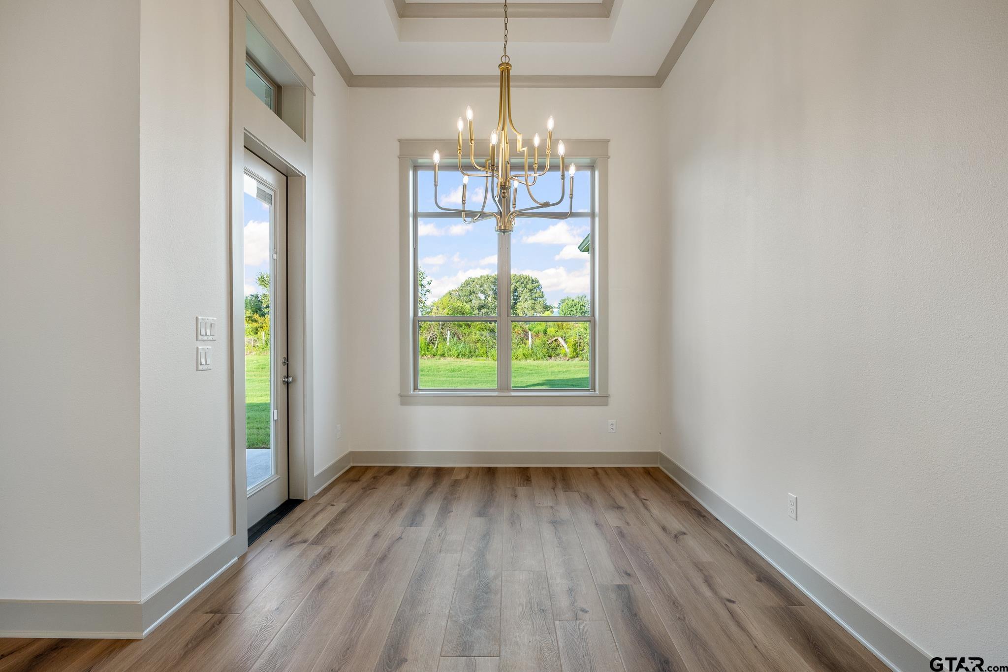 11410 Tucker Circle Flint, TX 75762 - Photo 20 of 43 a view of an empty room with wooden floor and a window