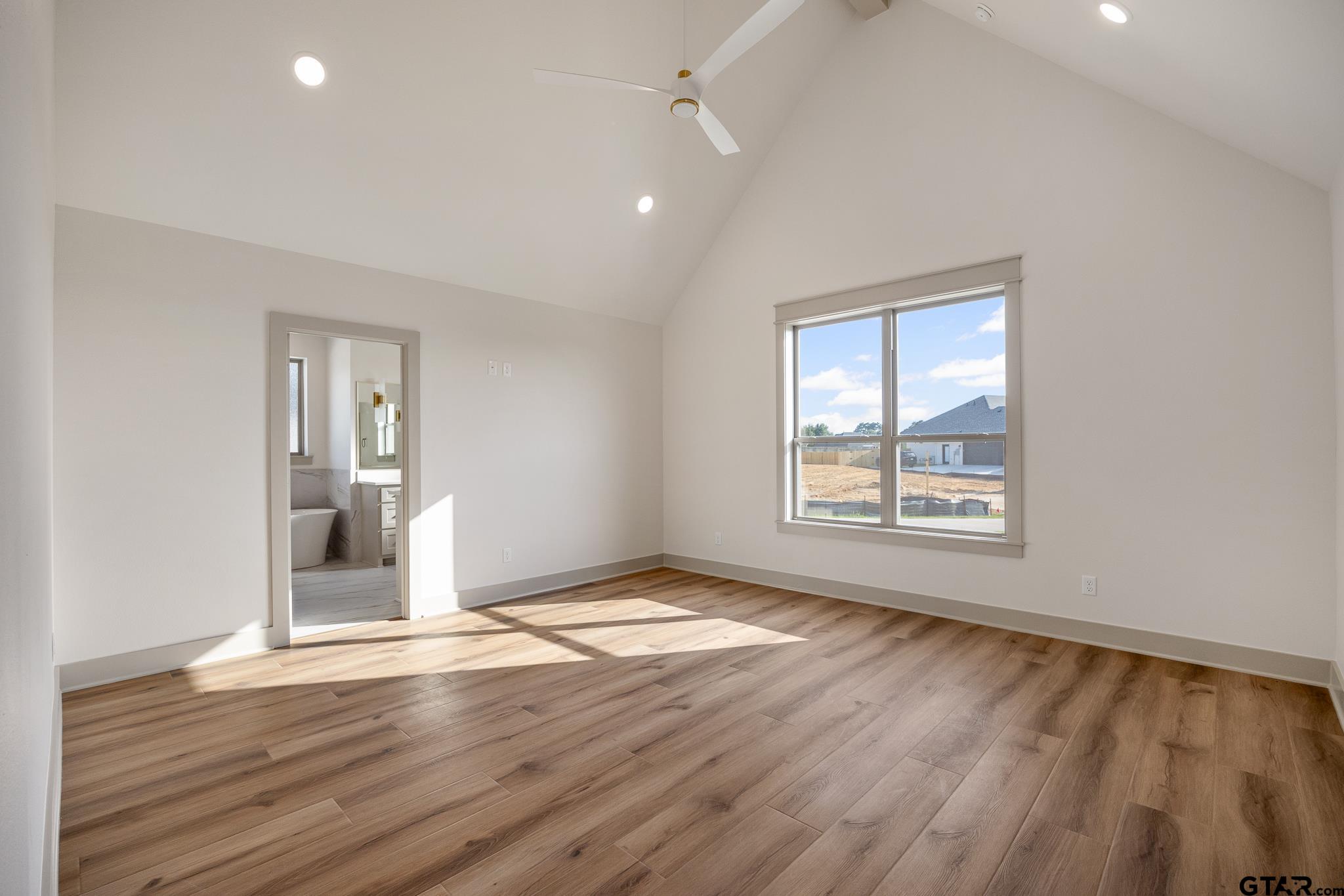 11410 Tucker Circle Flint, TX 75762 - Photo 27 of 43 an empty room with wooden floor and windows