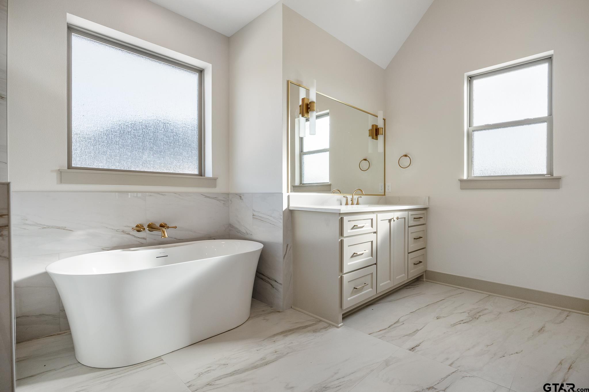 11410 Tucker Circle Flint, TX 75762 - Photo 30 of 43 a spacious bathroom with a bathtub sink and window