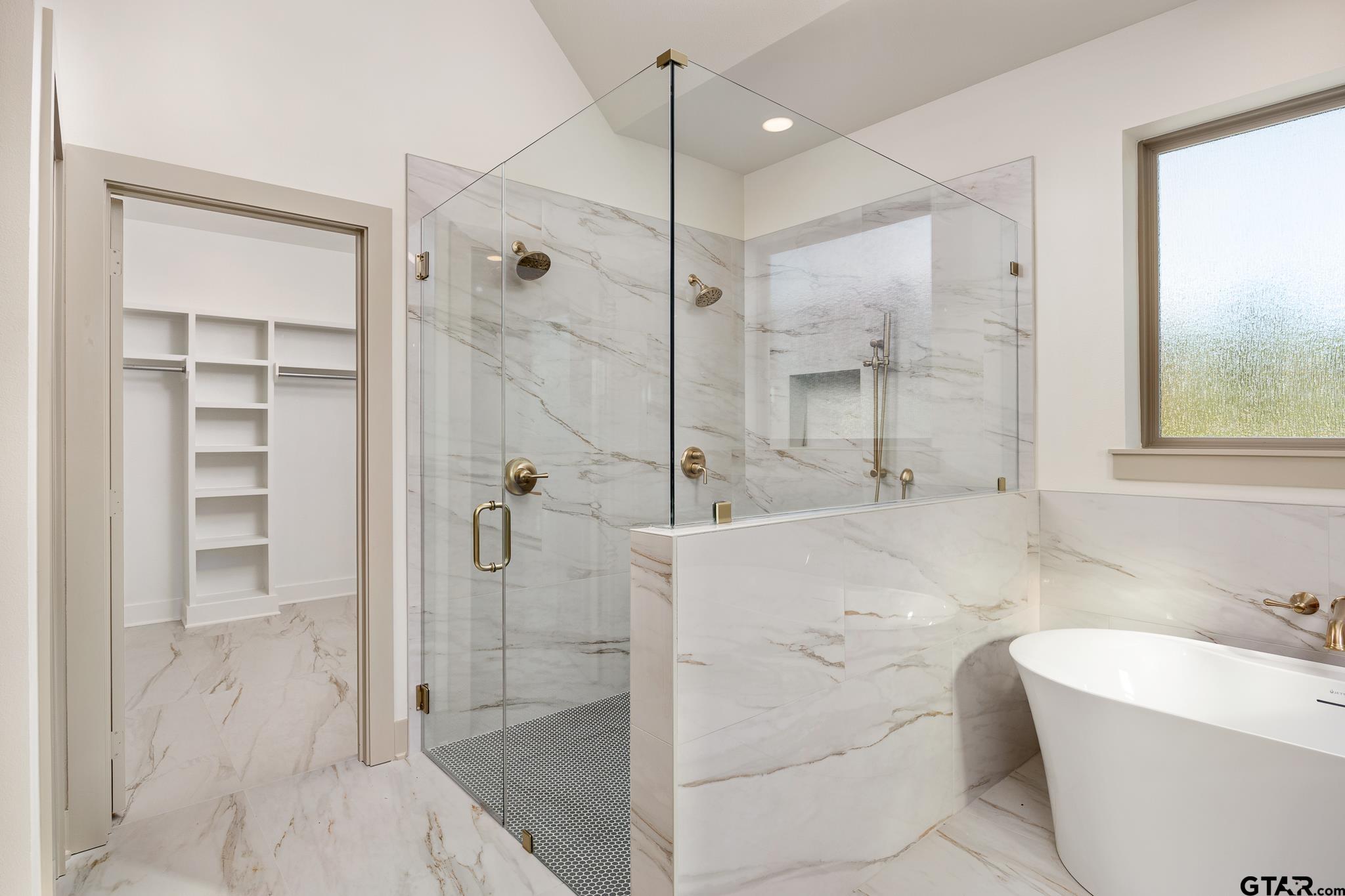 11410 Tucker Circle Flint, TX 75762 - Photo 31 of 43 a bathroom with a bathtub and a shower