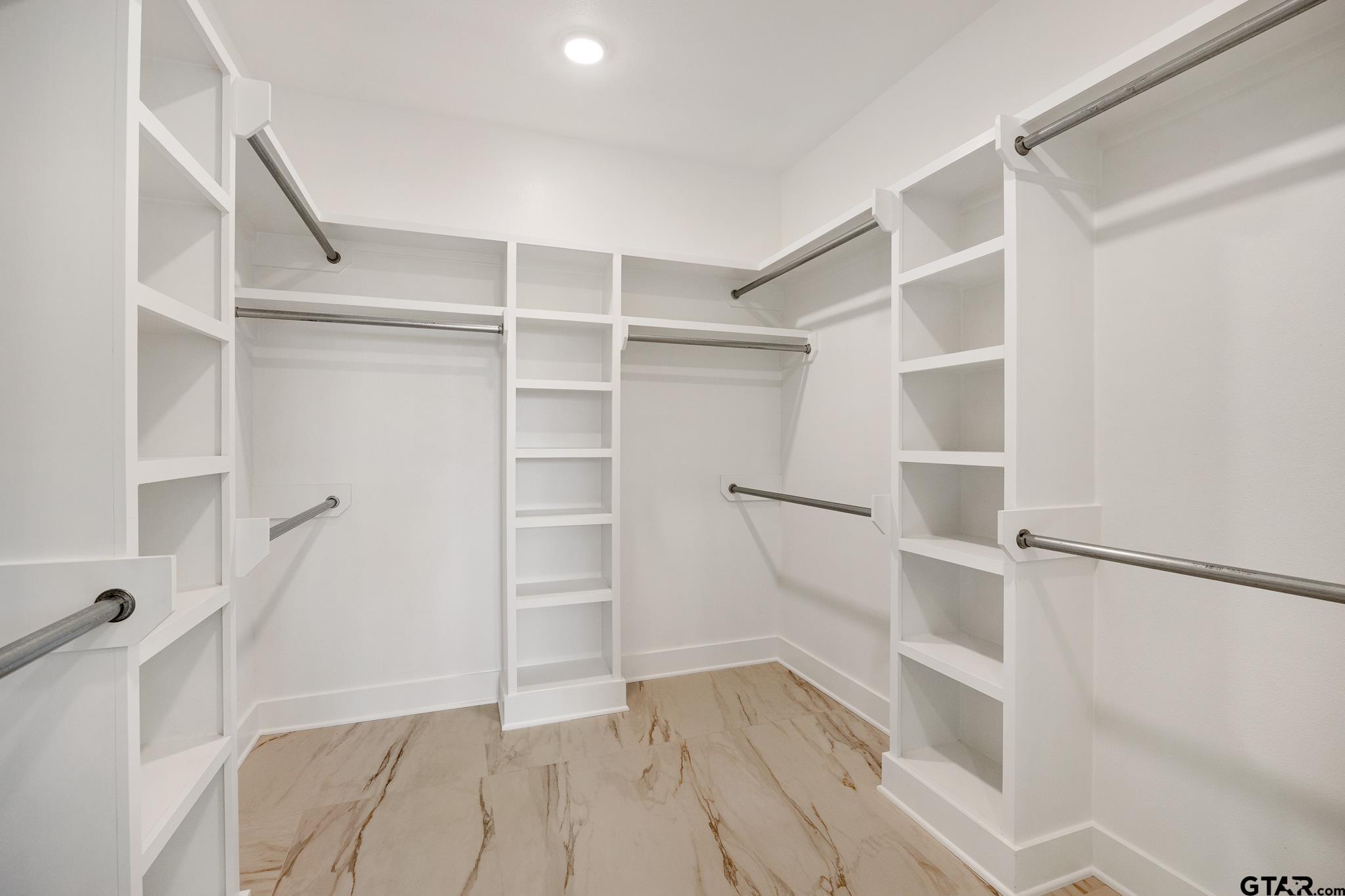 11410 Tucker Circle Flint, TX 75762 - Photo 33 of 43 a view of walk in closet with empty racks