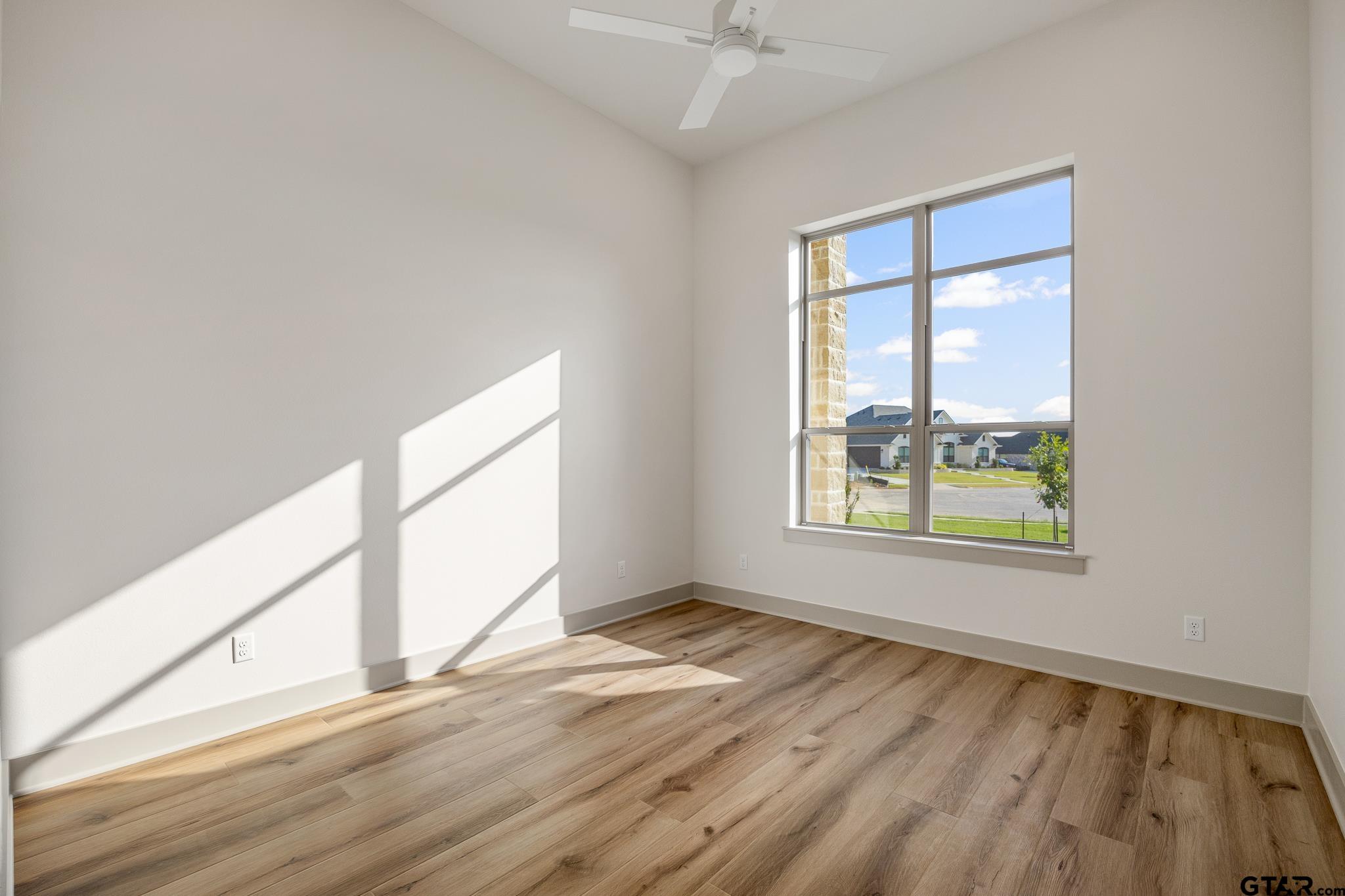 11410 Tucker Circle Flint, TX 75762 - Photo 34 of 43 a view of an empty room with wooden floor and a window