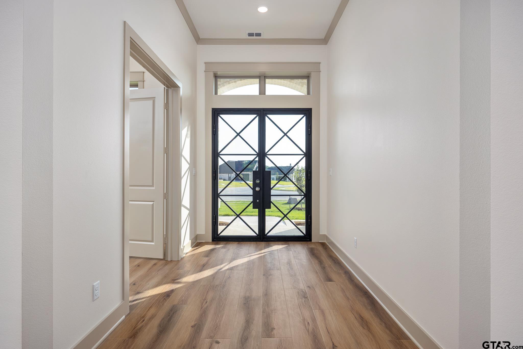 11410 Tucker Circle Flint, TX 75762 - Photo 7 of 43 an empty room with wooden floor and windows