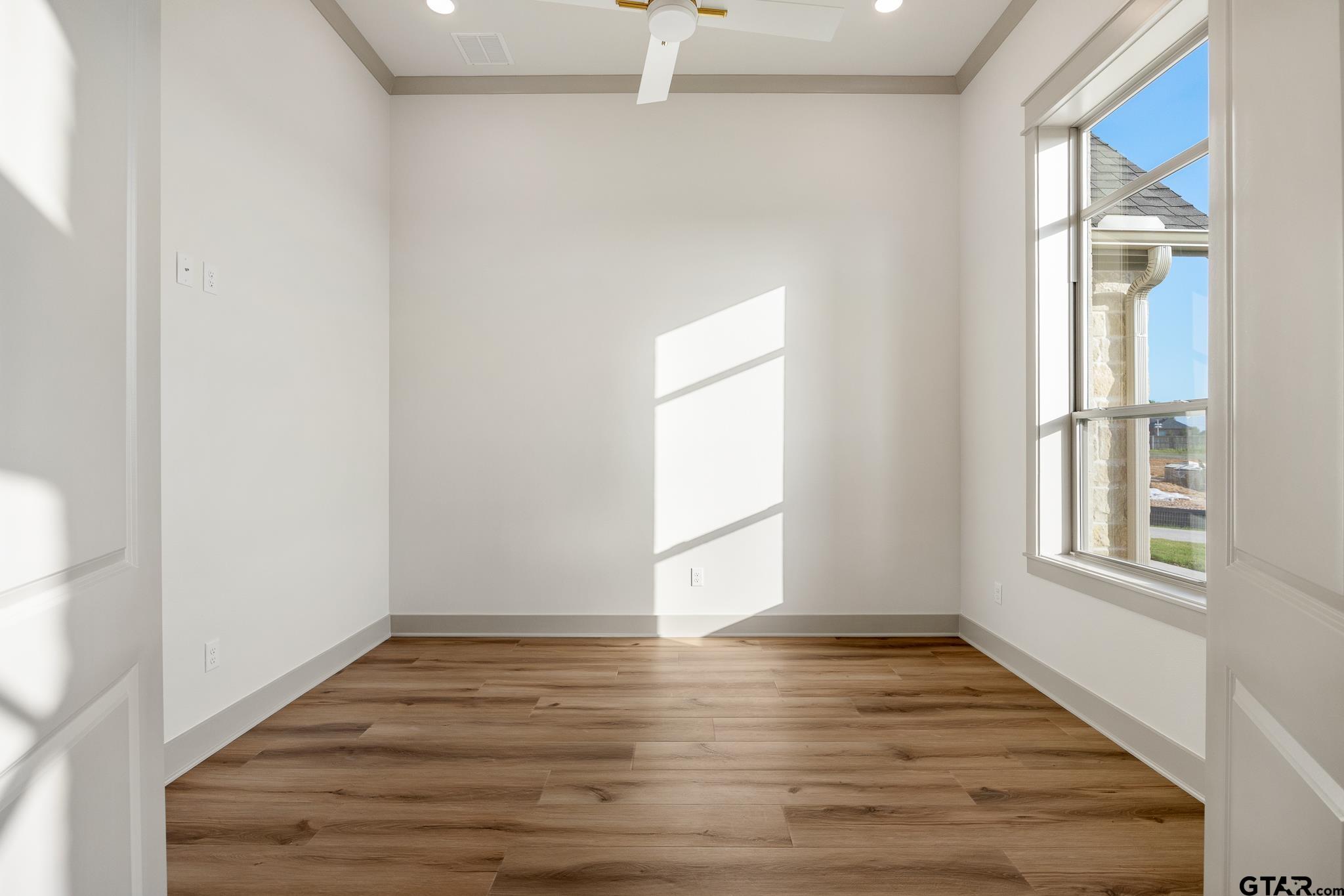 11410 Tucker Circle Flint, TX 75762 - Photo 9 of 43 an empty room with wooden floor and windows