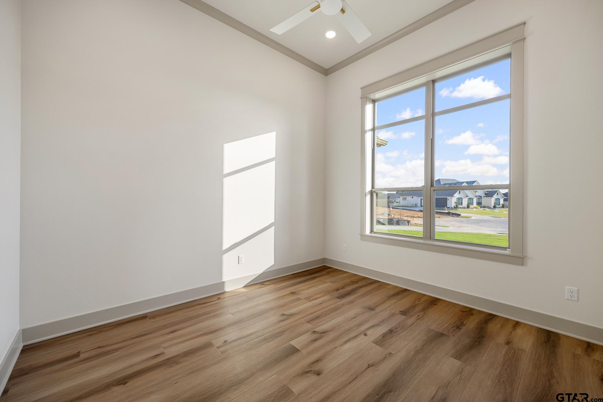 11410 Tucker Circle Flint, TX 75762 - Photo 10 of 43 an empty room with wooden floor and windows