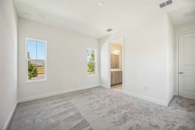 an empty room with windows and closet