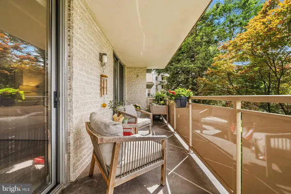 a front view of a house with a yard and potted plants