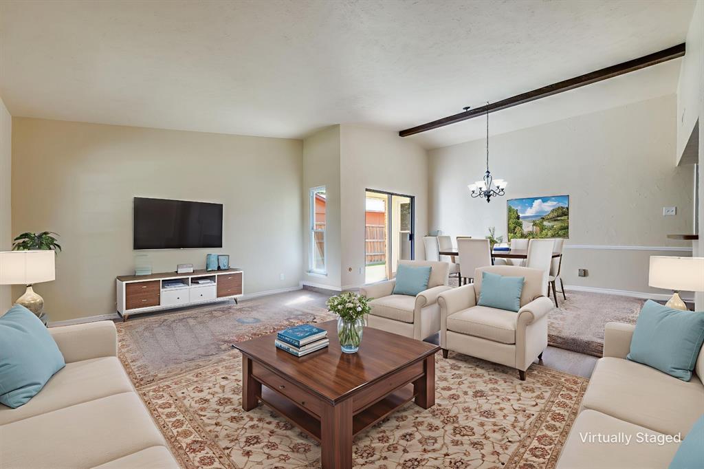 Living room featuring a chandelier and vaulted ceiling