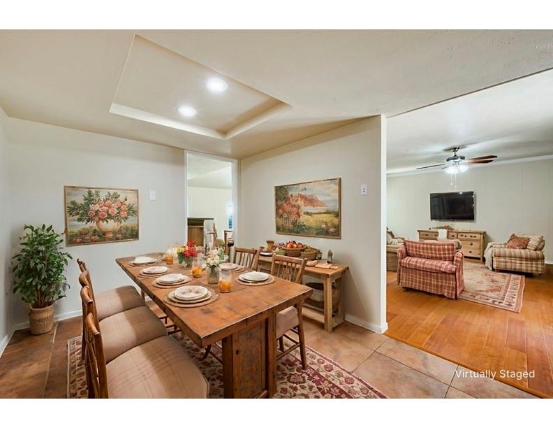 5044 Brandenburg Lane The Colony, TX 75056 - Photo 12 of 33 Dining room with a raised ceiling, tile patterned floors, recessed lighting, and ceiling fan