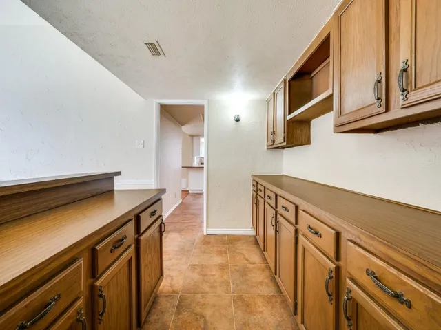 a kitchen with stainless steel appliances granite countertop a sink and cabinets