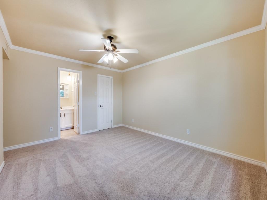 5044 Brandenburg Lane The Colony, TX 75056 - Photo 22 of 33 Primary bedroom featuring ornamental molding, light carpet, ceiling fan, and ensuite bathroom
