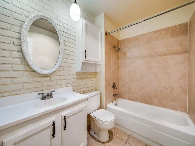 a bathroom with a toilet a sink and bathtub
