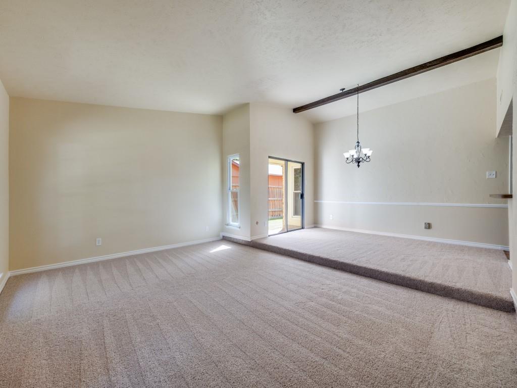 5044 Brandenburg Lane The Colony, TX 75056 - Photo 4 of 33 Carpeted Living space that leads into the formal dining area with a chandelier and wood beam