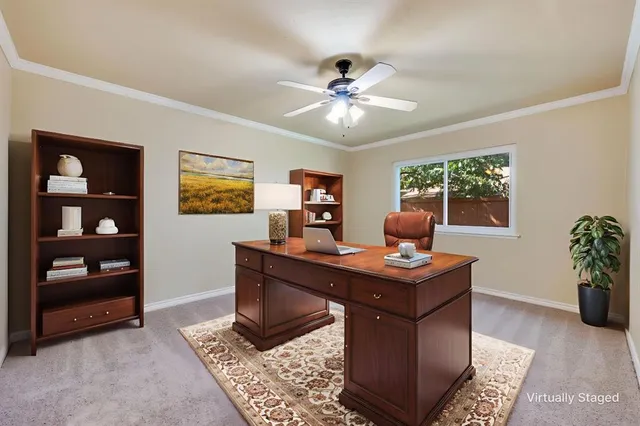 a view of a workspace with furniture and window